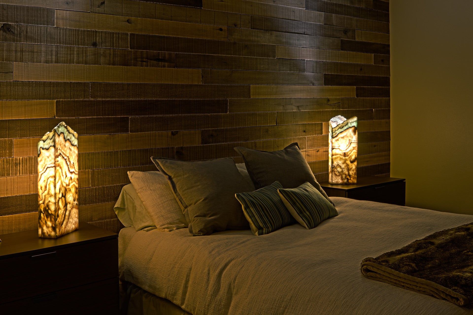 Oasis onyx marble table lamps in front of wooden wall